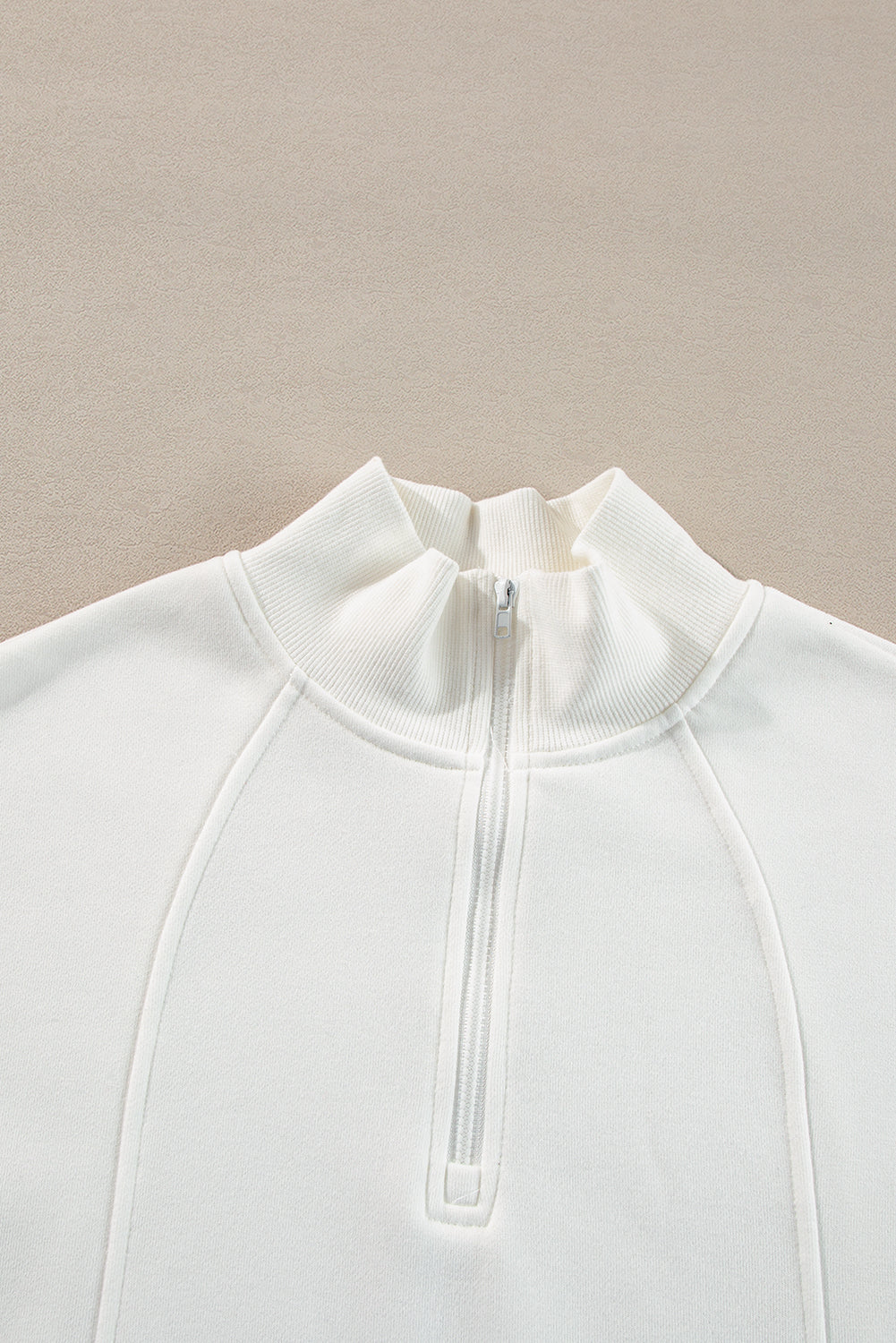 Sudadera blanca con cuello con cremallera y hombros caídos