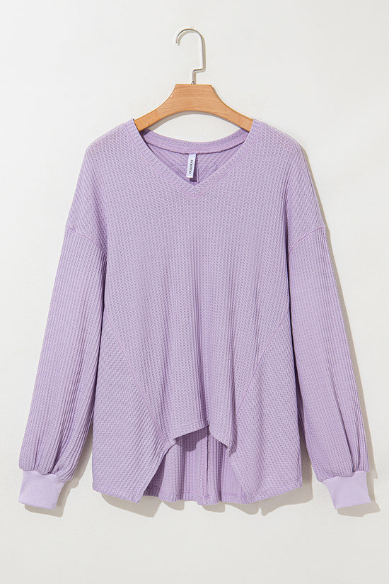 Ample blouse with embossed orchid petals, V -neck, long sleeves, falling shoulders