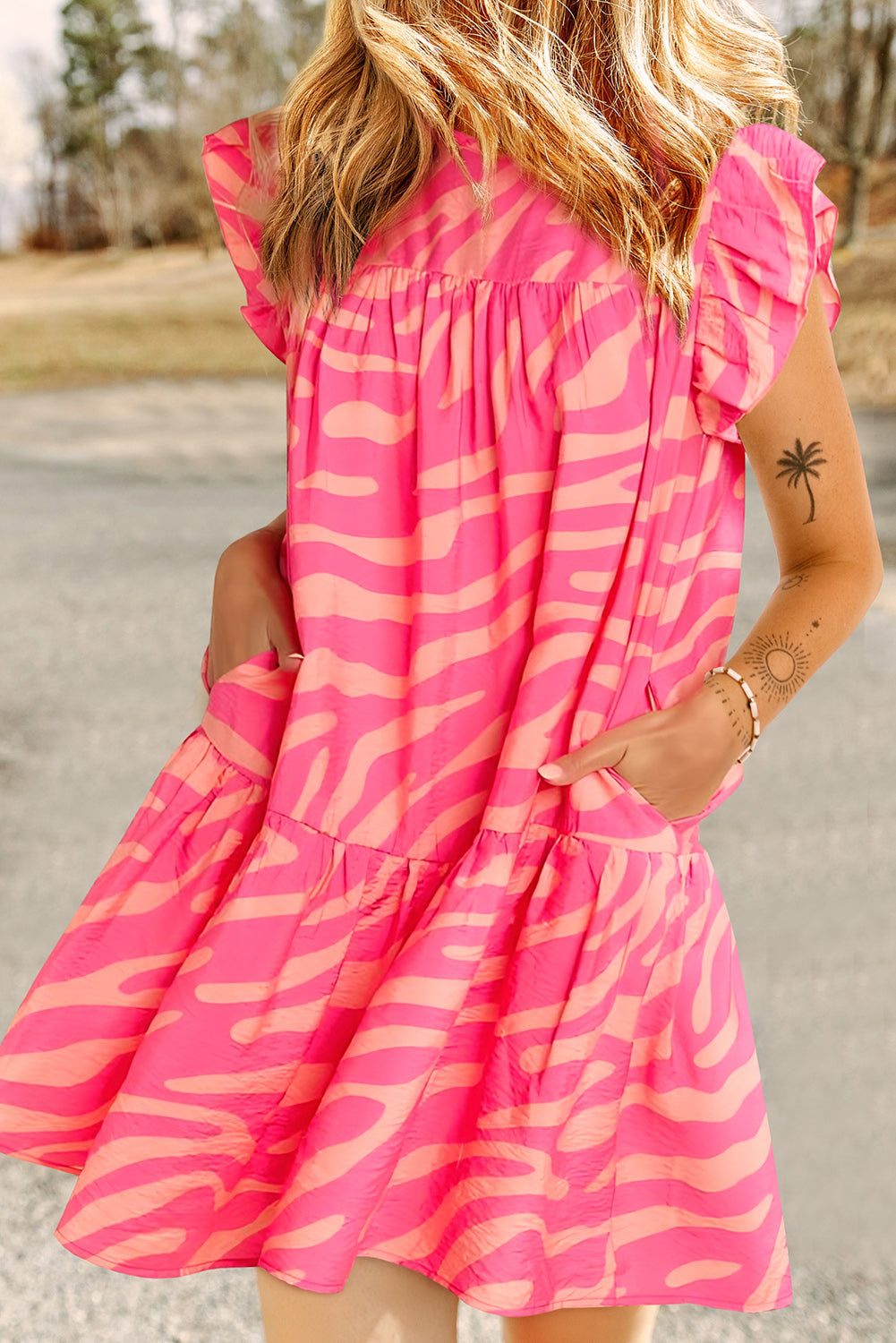 Pink dress with pockets and ruffle border printed with zero stripes
