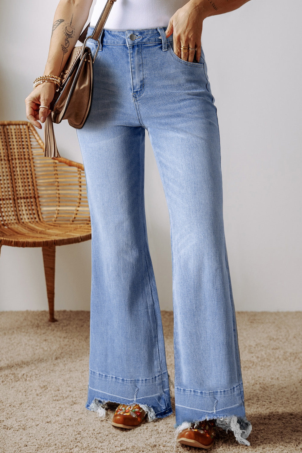 High blue flared jeans faded with acid with raw hem