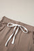 Dark brown jogging pants with pockets and tightening cord at the waist