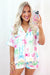 White pajama set with buttoned shirt and high waist short printed bow tie