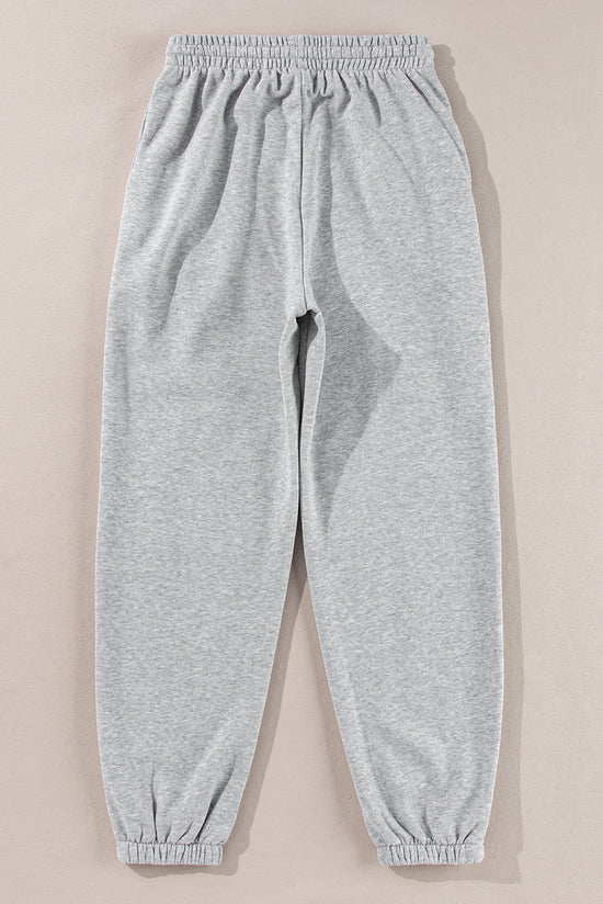 Pantalon de jogging gris clair à la taille avec cordon de serrage et doublure en polaire de couleur unie