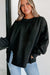 Black sweatshirt with exposed seams, dropped shoulders, round neck, slits