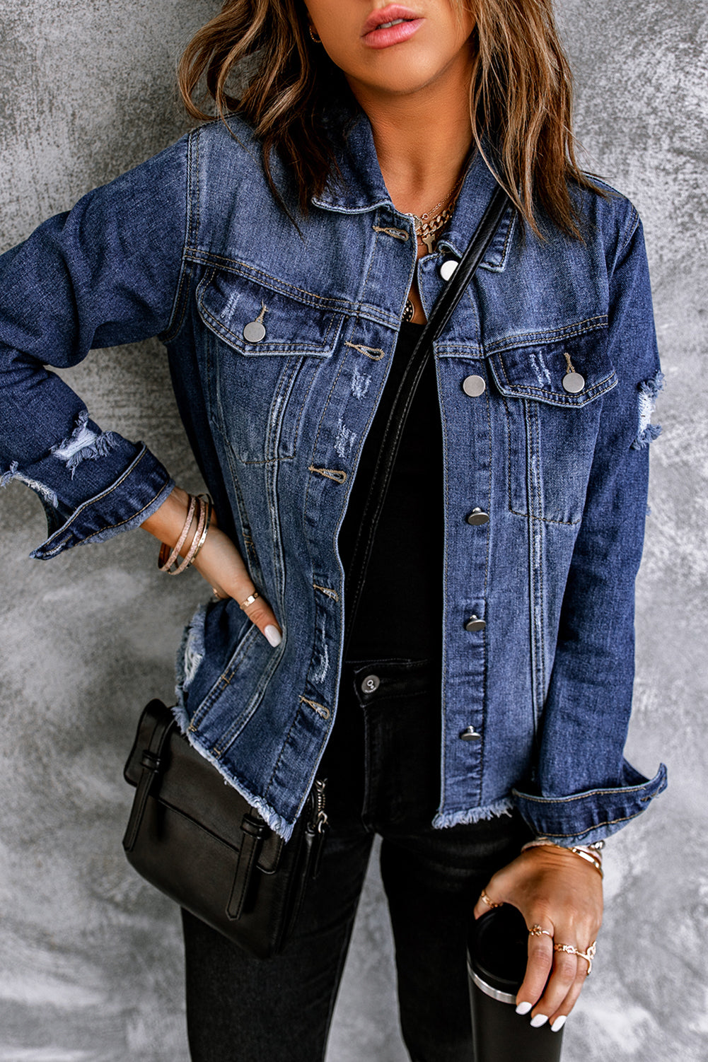 Blue distressed denim jacket with lapels and raw hem buttons