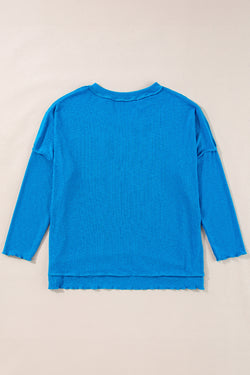 Blue long sleeve v-neck ribbed knit top with exposed seams