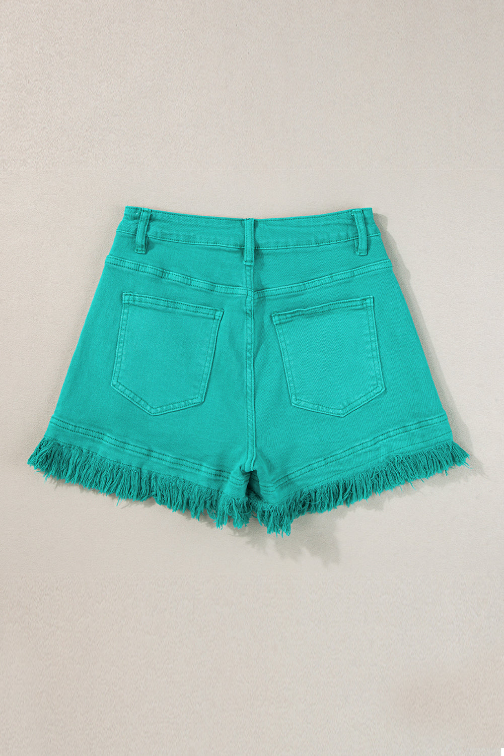 Mid-rise denim shorts with frayed edges in turquoise