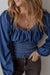 Smocked dark blue jeans blouse with ruffles and puffy sleeves in V -neck