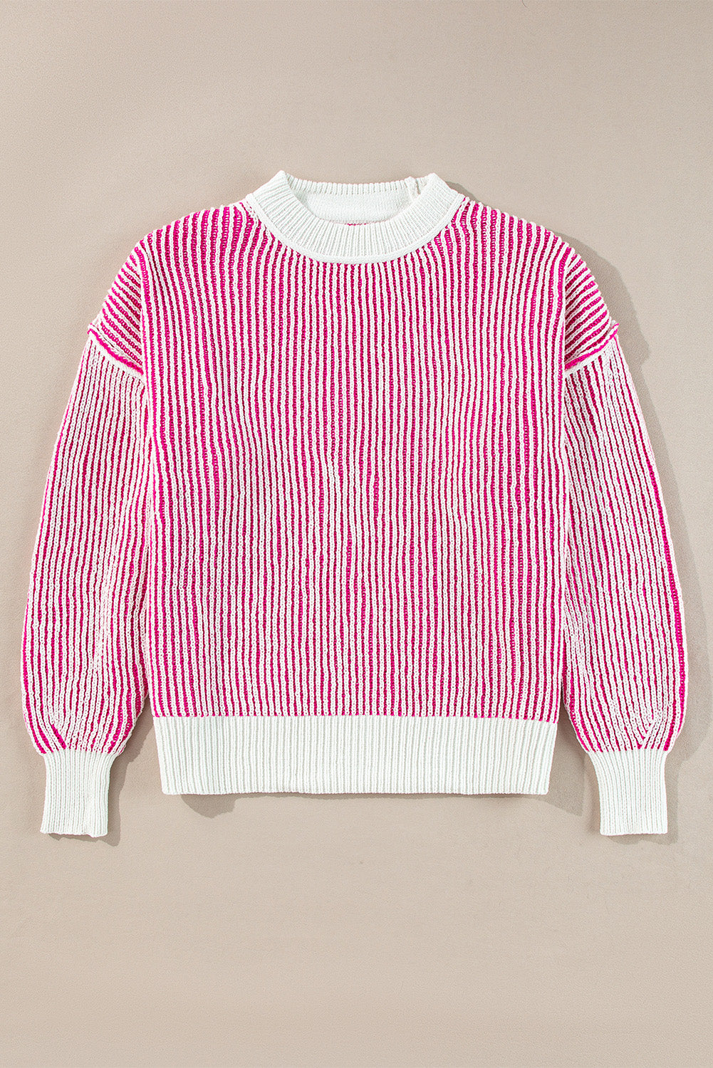 Loose-fitting sweater with contrasting edges in a textured knit with bright pink stripes