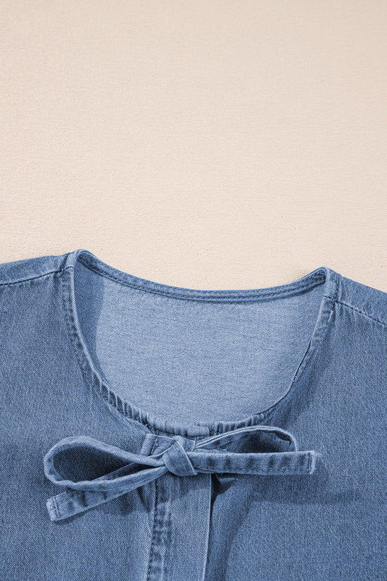 Twilight blue denim shirt tied on the front with bubble and basque sleeves