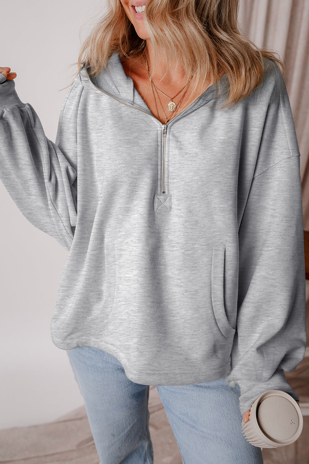 Light grey loose hoodie with half zip and fleece-lined kangaroo pockets