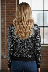 Blusa corta negra con brillo y cuello redondo con mangas largas