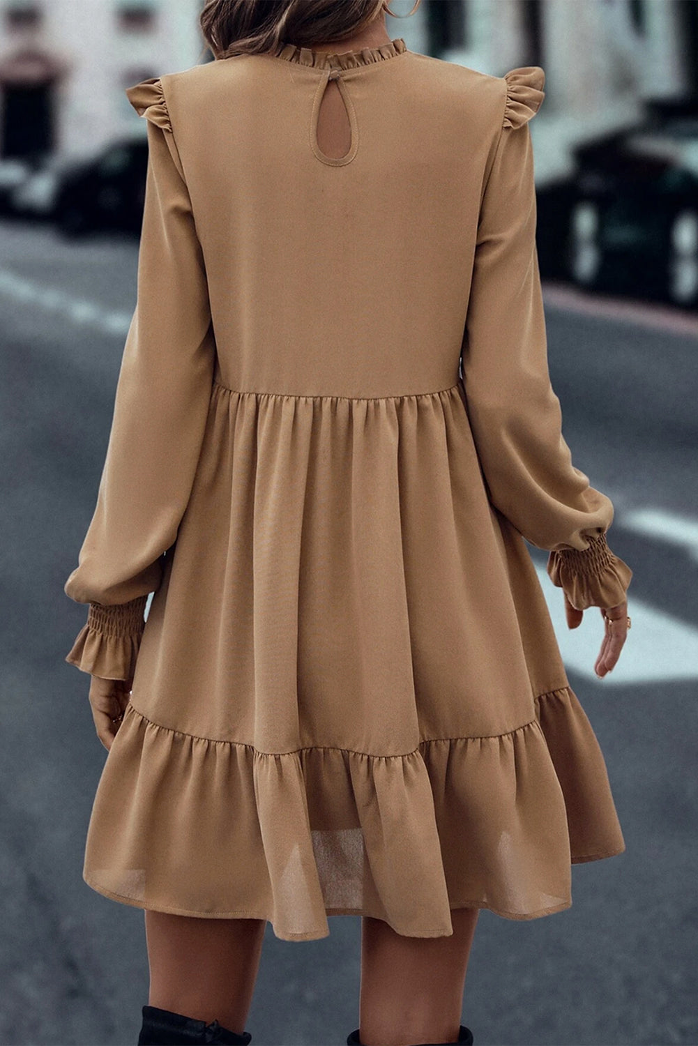 Tiered dress with ruffled shoulders and ruffled collar in light French beige