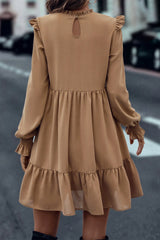 Tiered dress with ruffled shoulders and ruffled collar in light French beige