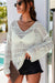 White V -neck sweater and openwork hook