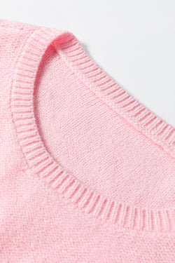 Pink knitted sweater with ribbed edges and flower pattern