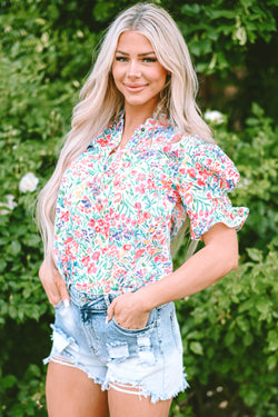 Pink blouse with floral print and buttoned, split collar, puffy sleeves