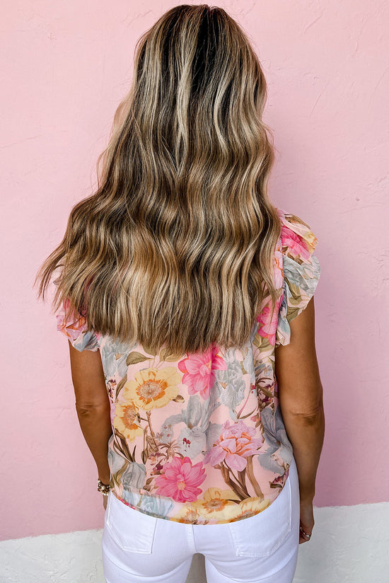 Pink blouse with short sleeves and floral print with pompom and tie