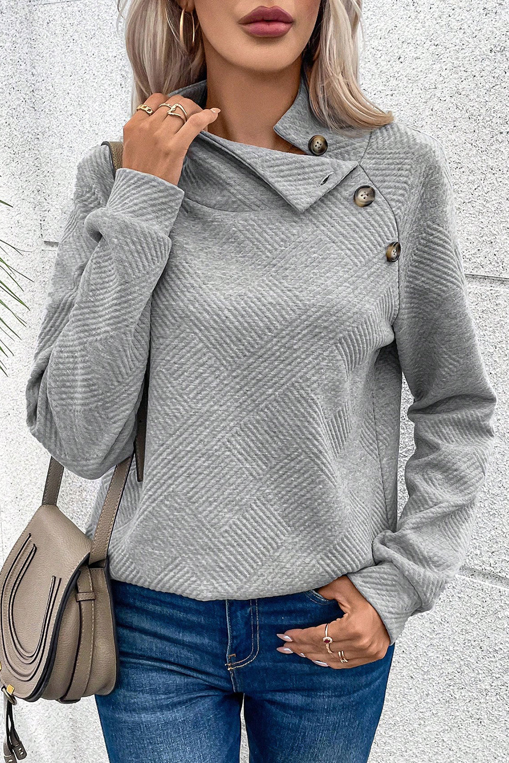 Grey textured sweatshirt with mock neck and asymmetrical buttons