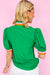 Short -sleeved blouse and V -neck with bright green colored edge