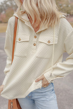 Apricot textured hoodie with button-down neckline and side pockets