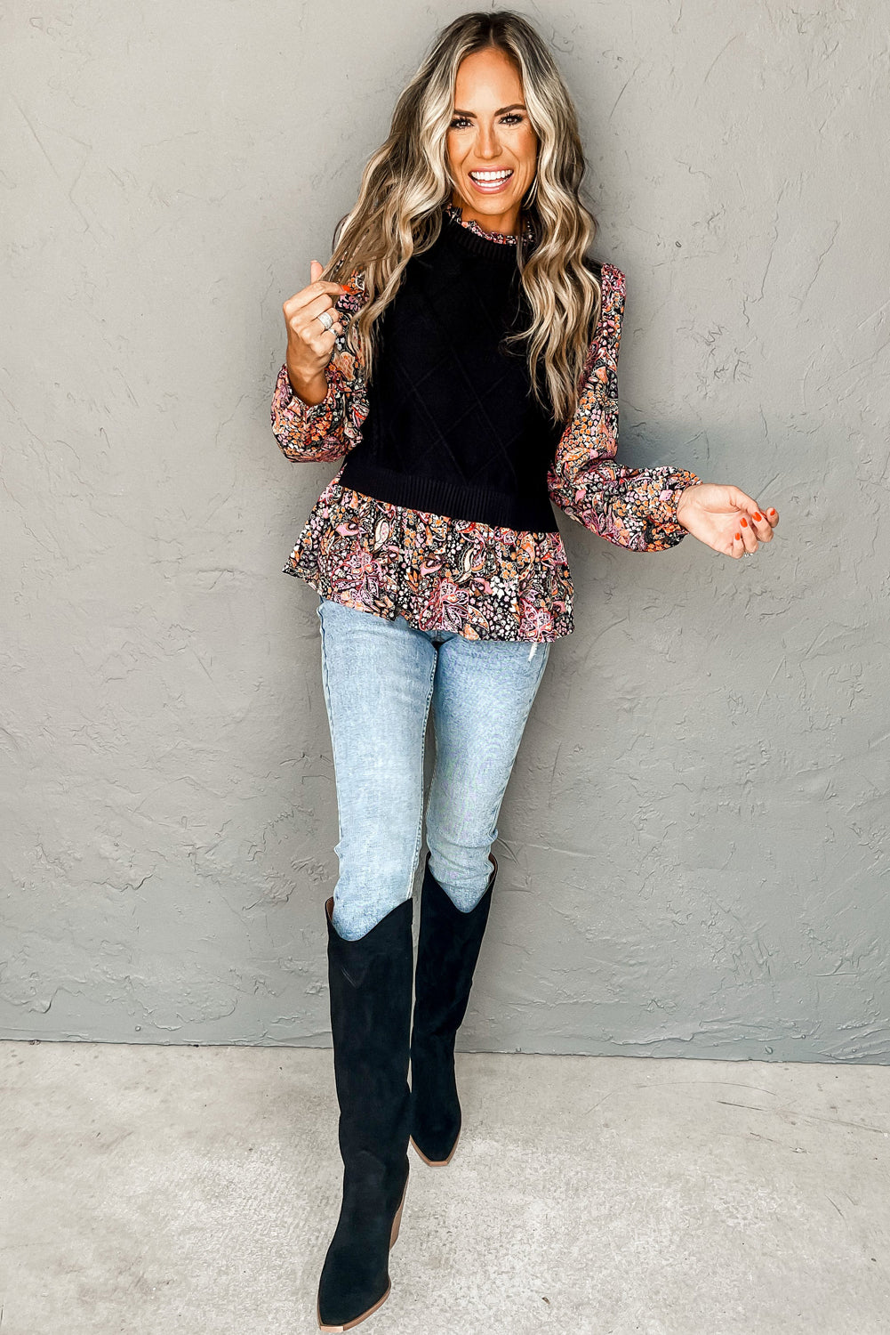 Black peplum sweater with contrasting floral sleeves