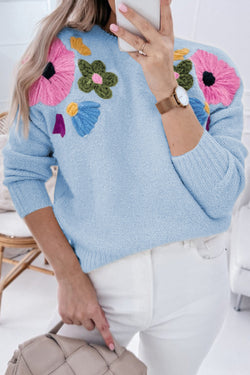 Light blue knitted sweater with ribbed edges with flowers pattern