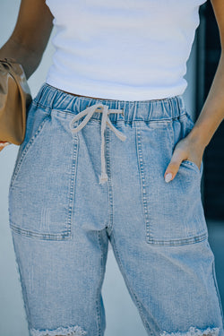 Denim jogging pants with round pockets in blue sky distress