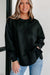 Black sweatshirt with exposed seams, dropped shoulders, round neck, slits