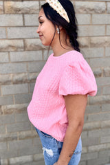 Camiseta rosa texturizada con mangas hinchadas