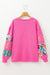 High pink sweater with mixed prints and drooping shoulder patches *