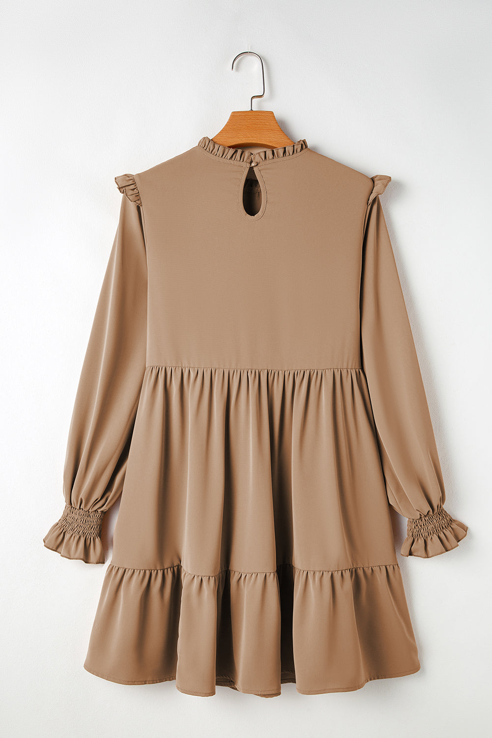 Tiered dress with ruffled shoulders and ruffled collar in light French beige