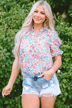 Pink blouse with floral print and buttoned, split collar, puffy sleeves