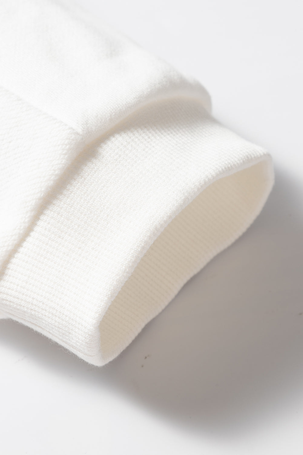 Sudadera holgada blanca con hombro caído y mosaicos lisos