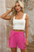 Large shorts with bright pink cargo pocket