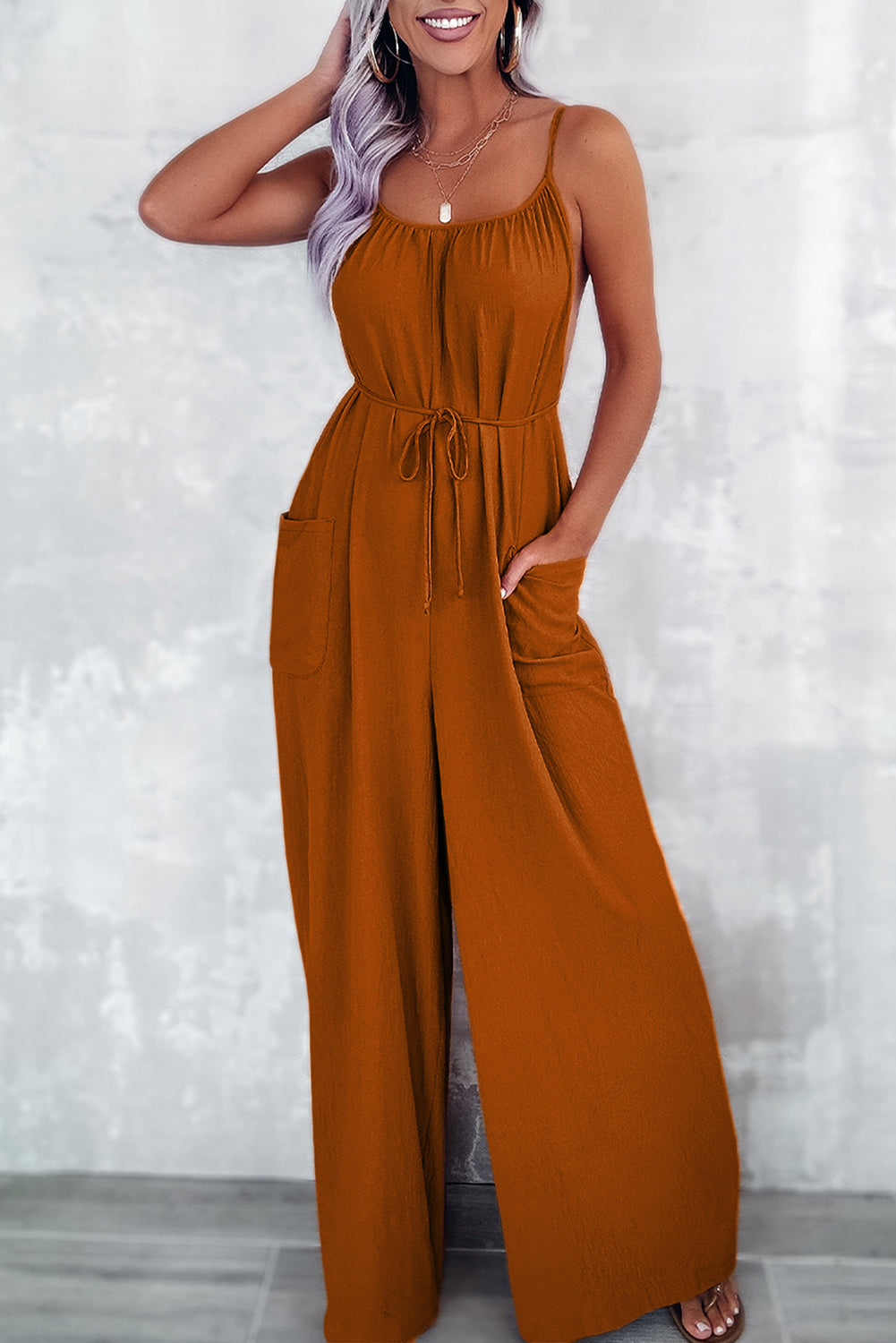 Chestnut jumpsuit with thin straps and tie at the waist, wide legs with pockets