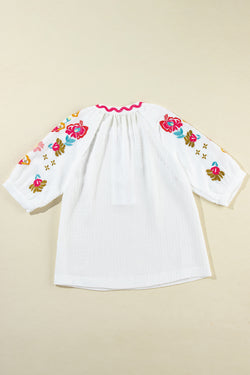 White textured blouse with puffy sleeves and Ricrac floral embroidery