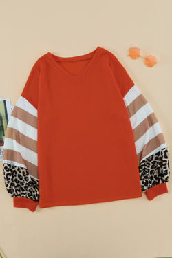 Orange top with lantern sleeves and leopard stripes