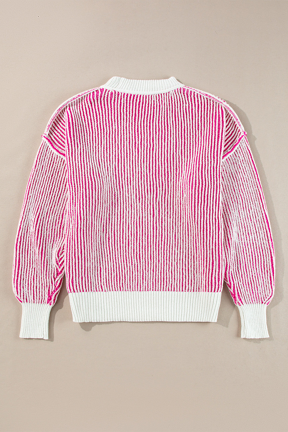 Loose-fitting sweater with contrasting edges in a textured knit with bright pink stripes