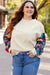 White textured sweater top with patchwork sleeves and large flowers