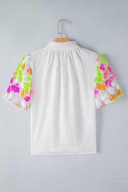 White textured high with smocked neck and sequined flowers and puffy sleeves