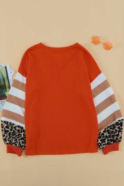 Orange top with lantern sleeves and leopard stripes