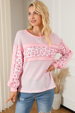 Waffle knit top with exposed seams and pink leopard patchwork