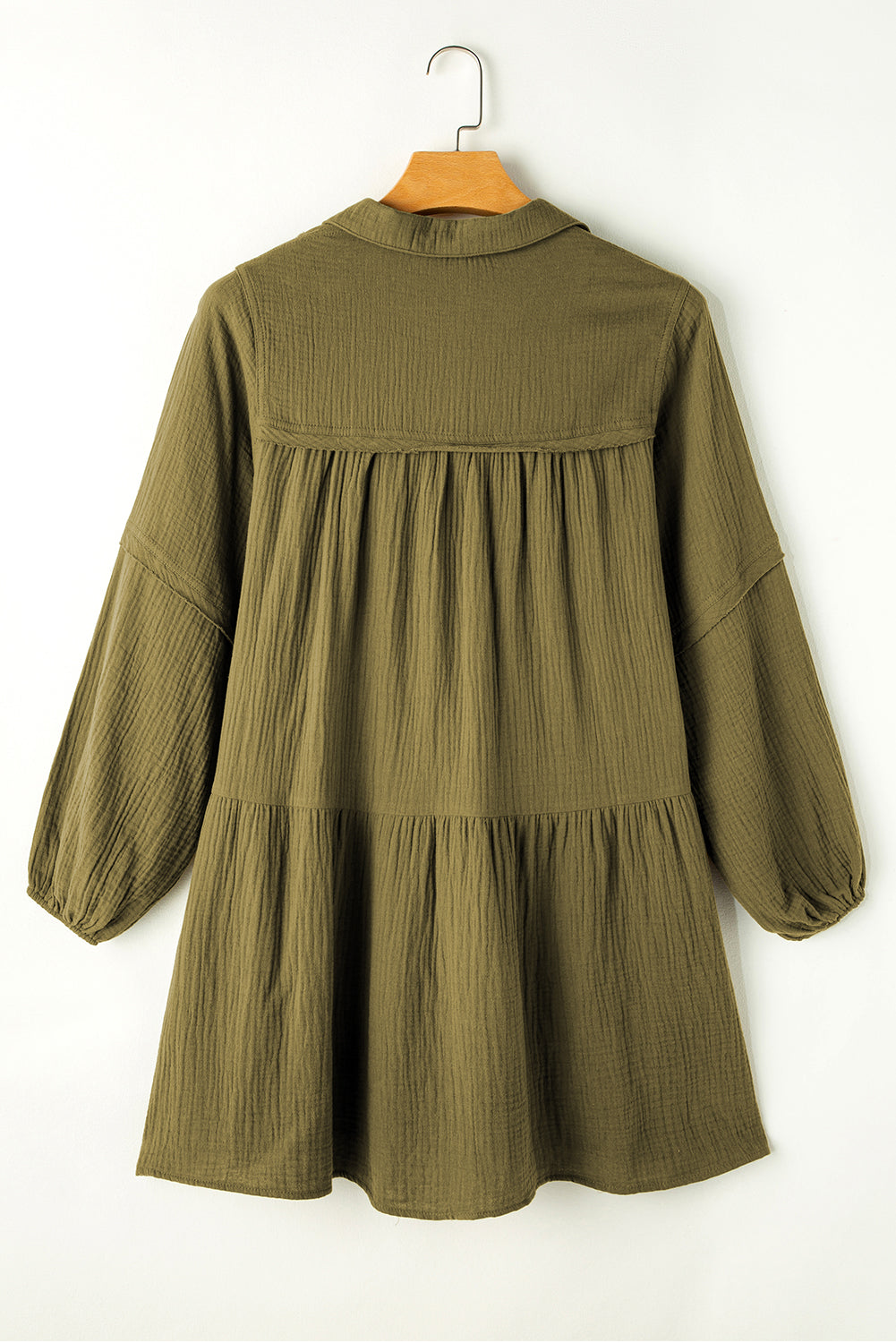 Green flared dress with frayed edging, split collar, puffed sleeves