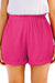 Large pink textured shorts with rolled edges and ruffles, elastic waist