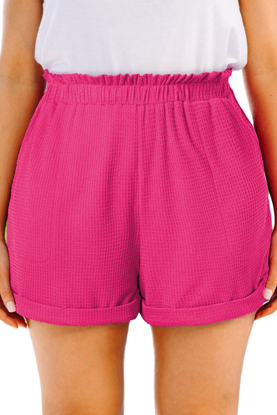 Large pink textured shorts with rolled edges and ruffles, elastic waist