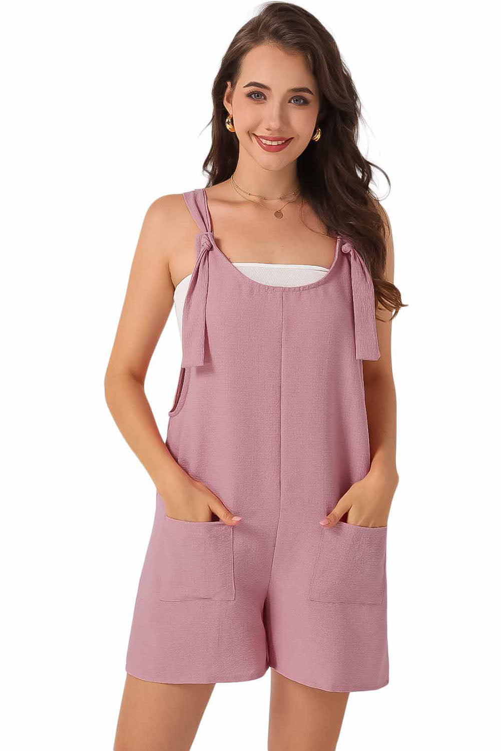 Pink textured romper with adjustable straps and pockets