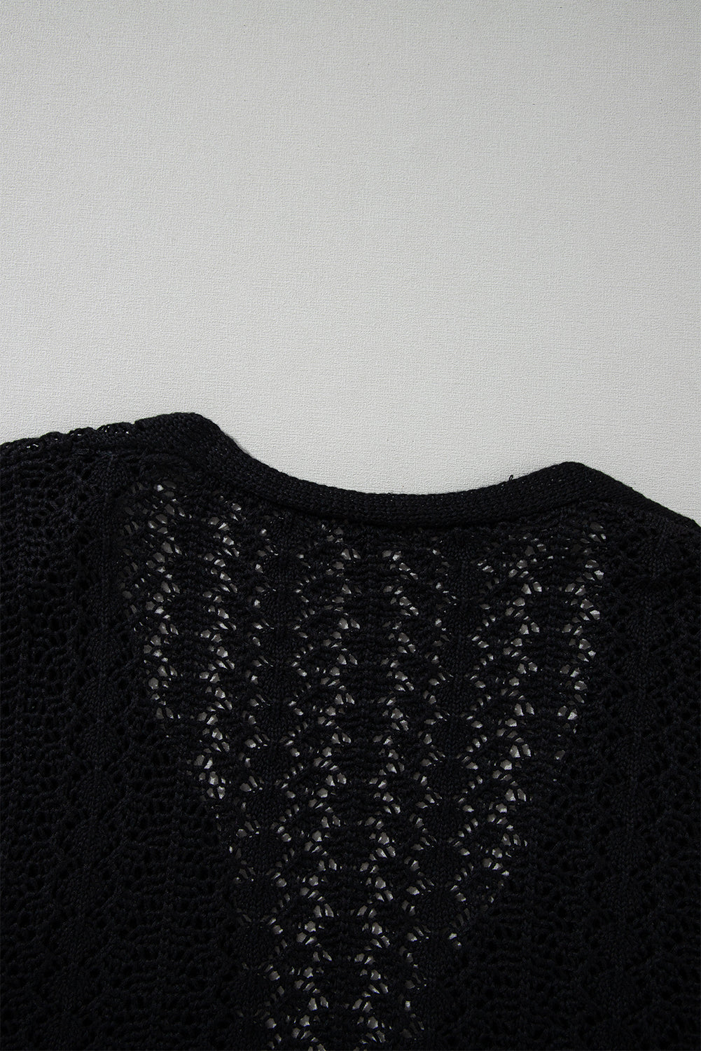 Black open front cardigan in openwork knit with dropped shoulders