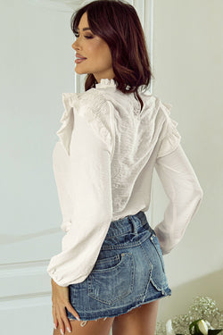 White blouse with puffy sleeves and ruffle border and ruffle collar