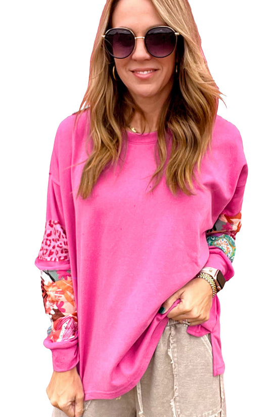 High pink sweater with mixed prints and drooping shoulder patches *